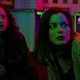 Fear Street characters hunker down in neon-lit terror in a scene from the film trilogy.